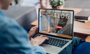 person reading a blog on a laptop